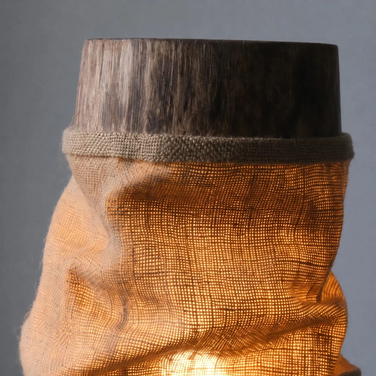 Close-up of gathered shade top rim and wood finish