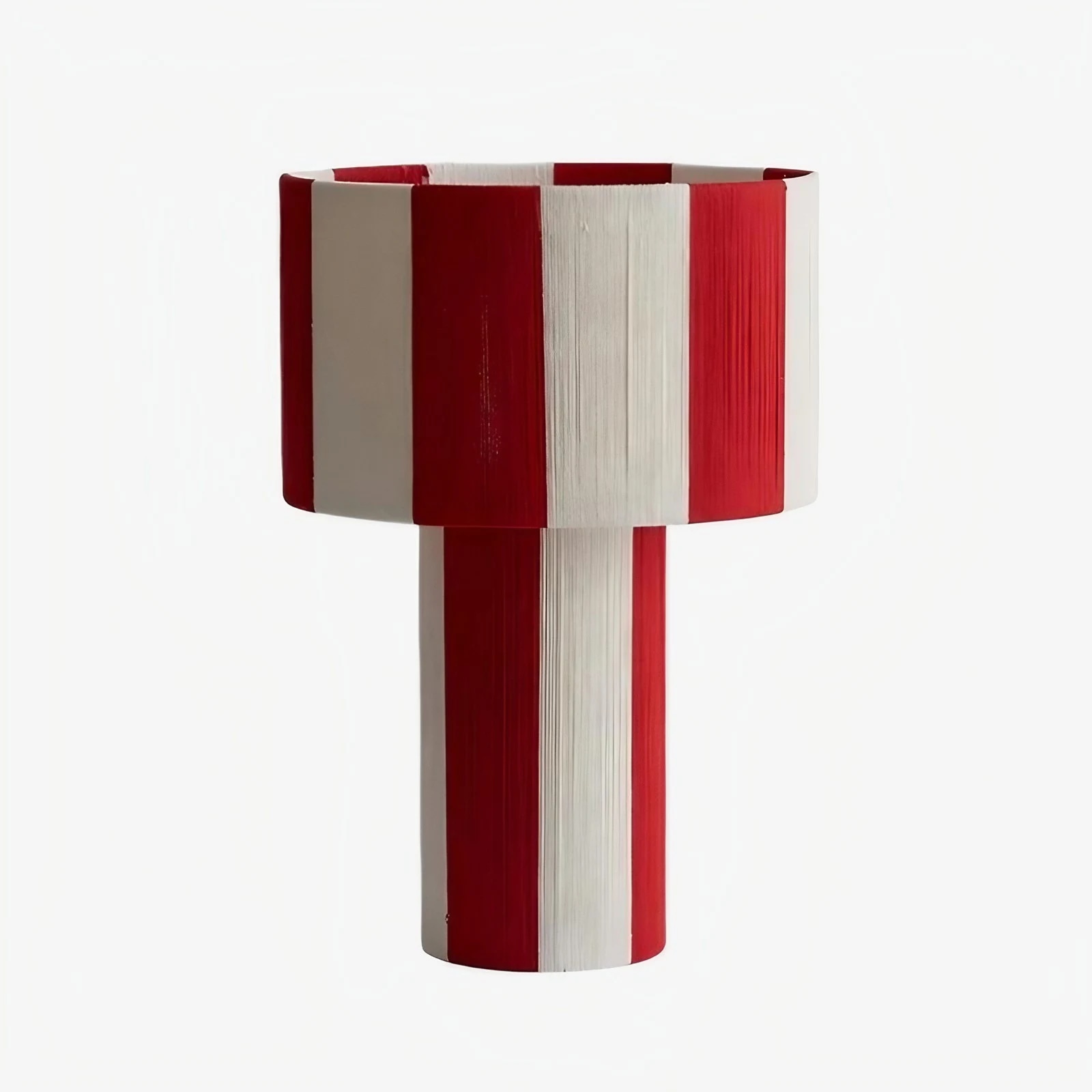Red and white striped woven shade table lamp on a white background